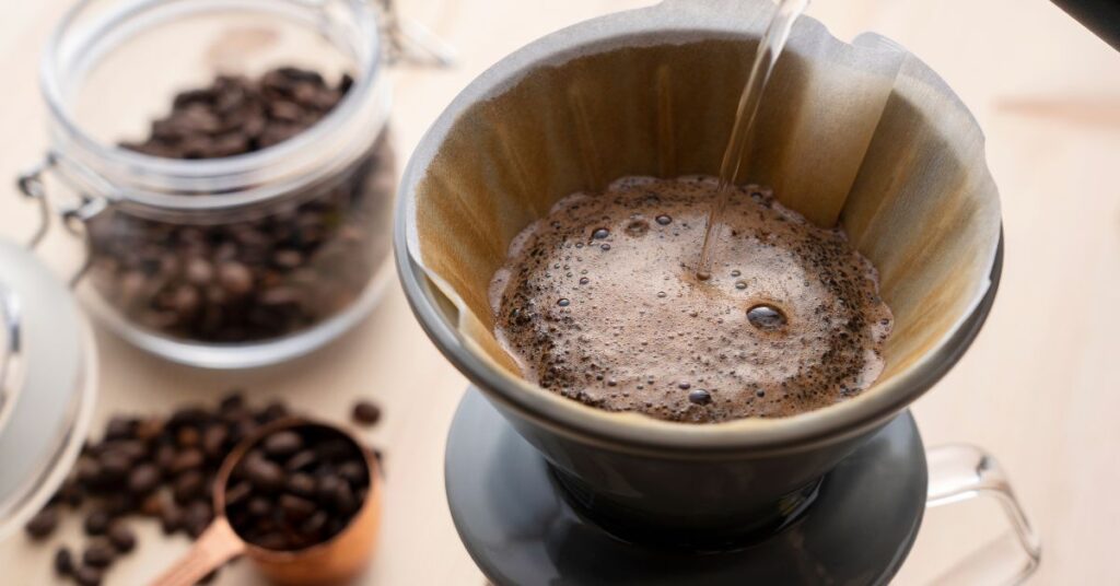 Pouting hot water into a pour over coffee device